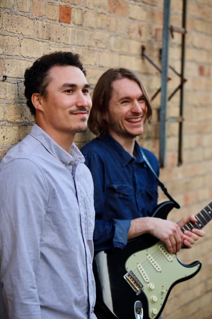 FORM band portrait against a brick wall
