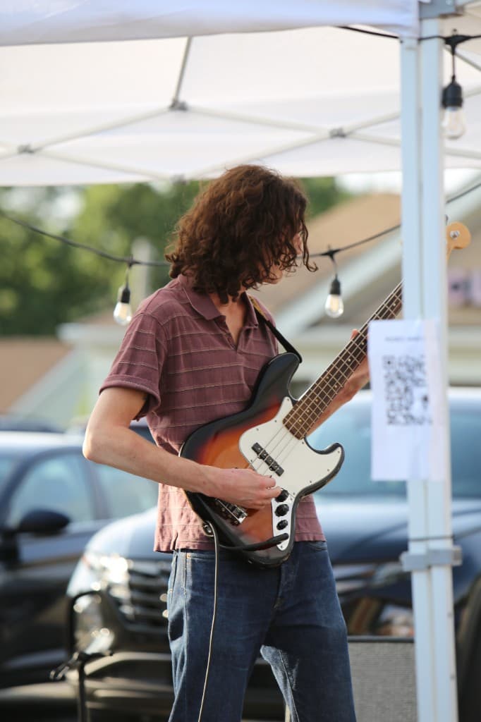FORM bassist playing live under a canopy